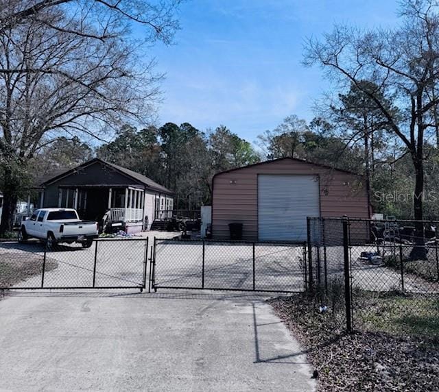 exterior space featuring driveway and a gate