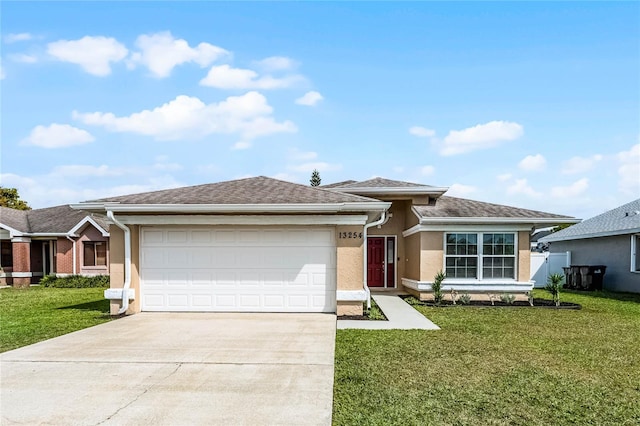 ranch-style house with a garage, concrete driveway, a front yard, and stucco siding