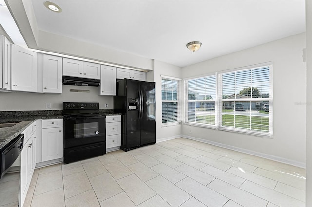 kitchen featuring baseboards, under cabinet range hood, black appliances, and light tile patterned floors