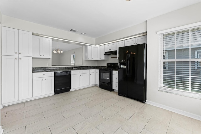 kitchen with dark countertops, visible vents, white cabinets, a sink, and black appliances