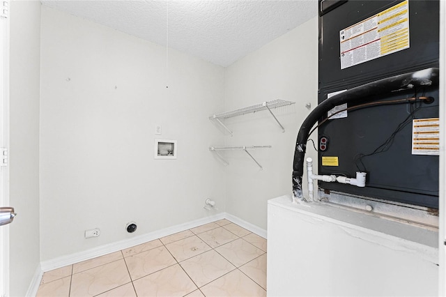 laundry room featuring laundry area, baseboards, hookup for a washing machine, a textured ceiling, and electric dryer hookup