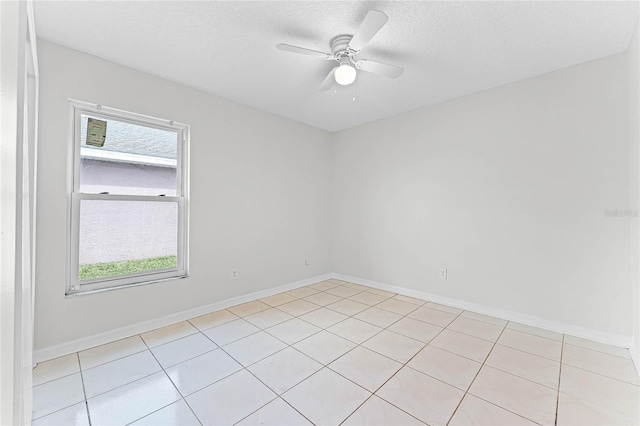 empty room featuring a textured ceiling, baseboards, and a ceiling fan