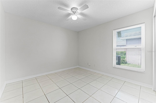 unfurnished room with ceiling fan, baseboards, and a textured ceiling