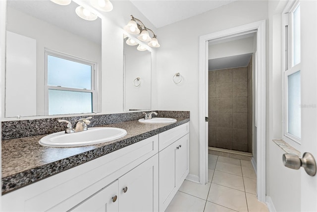 bathroom with double vanity, a sink, and tile patterned floors