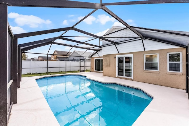 view of swimming pool with a patio, glass enclosure, fence, and a fenced in pool