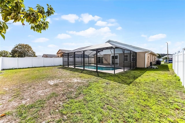 exterior space with a fenced in pool, glass enclosure, a fenced backyard, and a lawn