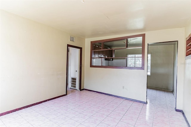 spare room featuring visible vents and baseboards