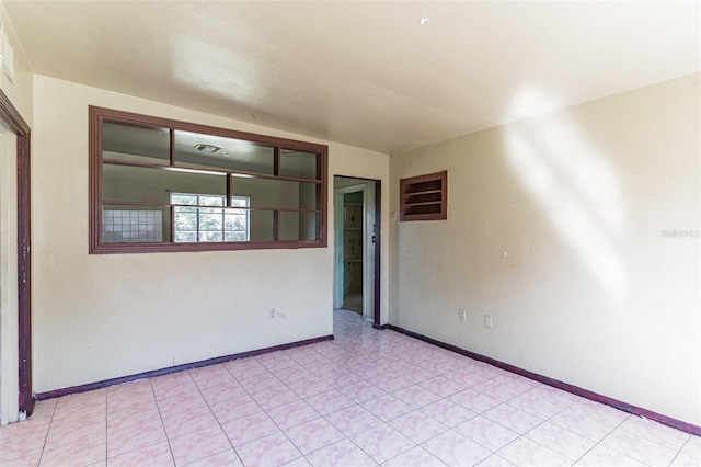 spare room with baseboards