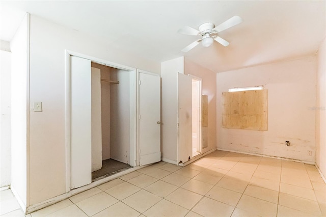 unfurnished bedroom featuring light tile patterned flooring and a ceiling fan