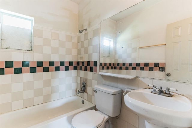 bathroom with decorative backsplash, toilet, shower / tub combination, a sink, and tile walls