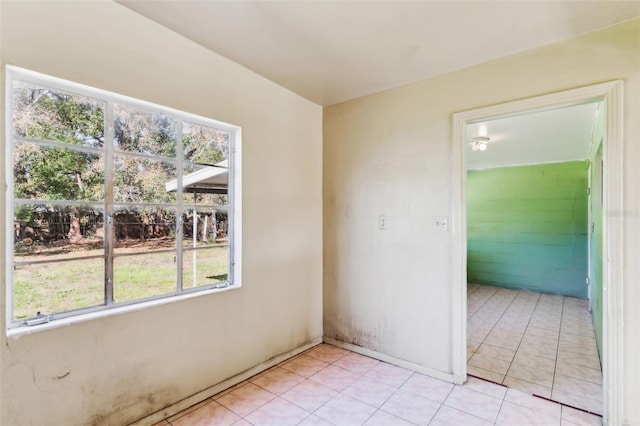 unfurnished room with light tile patterned floors