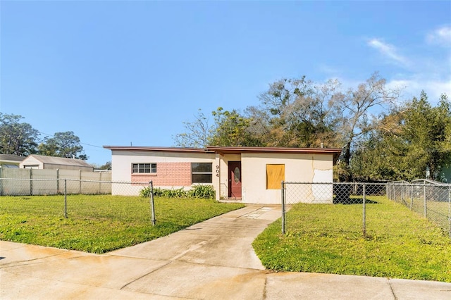 view of front facade with fence private yard and a front yard