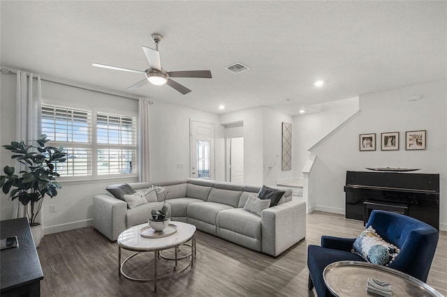 living area with recessed lighting, visible vents, ceiling fan, wood finished floors, and baseboards