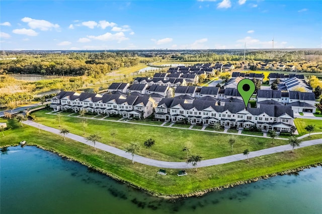 drone / aerial view with a residential view and a water view