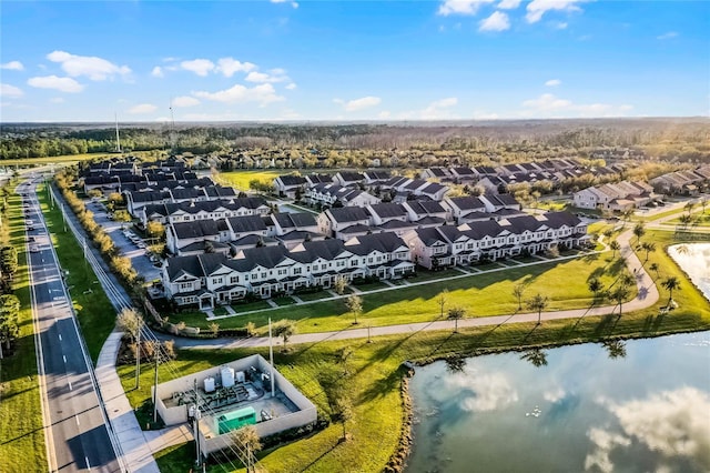 drone / aerial view with a water view and a residential view