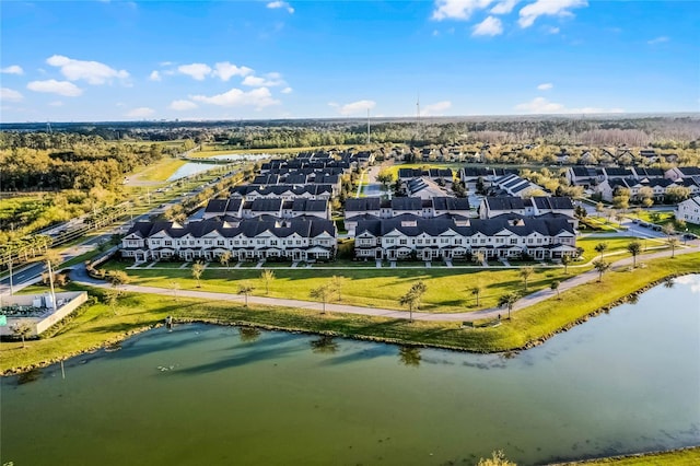 drone / aerial view featuring a residential view and a water view