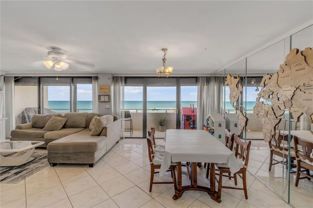 dining space with a water view, a wealth of natural light, and light tile patterned flooring