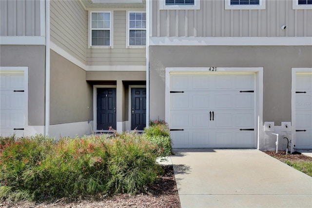 421 Sedgewick Dr, Davenport, FL 33837 - entrance to property featuring board and batten siding, stucco siding, and driveway