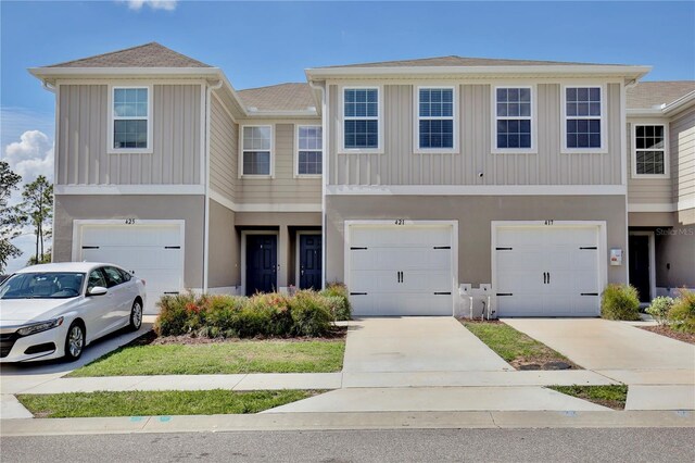 421 Sedgewick Dr, Davenport, FL 33837 - view of property featuring an attached garage and driveway