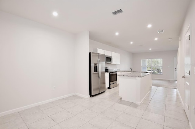 421 Sedgewick Dr, Davenport, FL 33837 - kitchen with stainless steel appliances, recessed lighting, white cabinetry, a kitchen island, and a sink