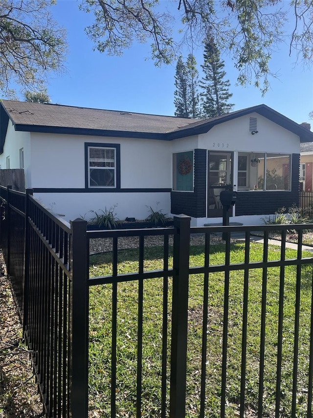 view of front of house with a fenced front yard and a front lawn