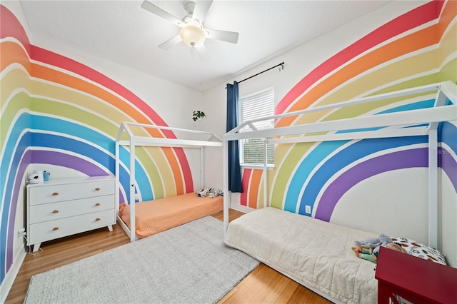 bedroom with ceiling fan and wood finished floors