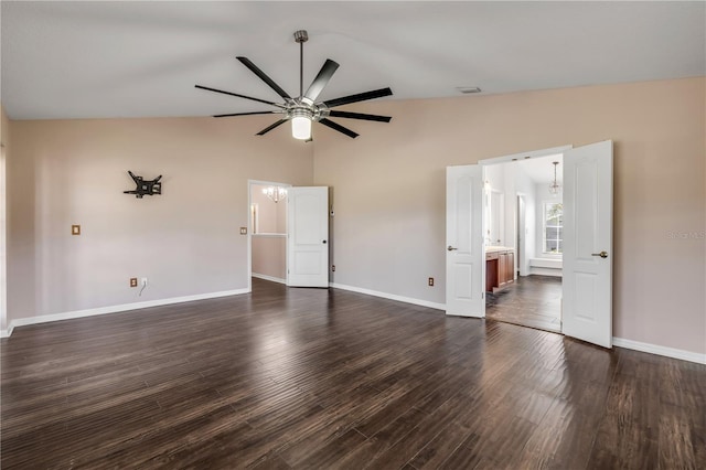 interior space with lofted ceiling, dark wood-style floors, and baseboards