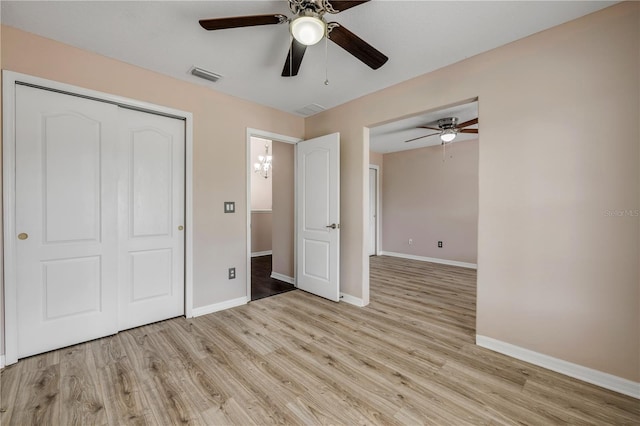 unfurnished bedroom with a closet, visible vents, light wood-style floors, a ceiling fan, and baseboards