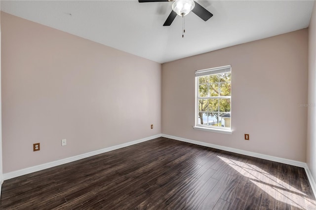 empty room featuring ceiling fan, dark wood-style flooring, and baseboards