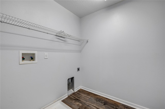 clothes washing area with dark wood-style floors, washer hookup, hookup for an electric dryer, laundry area, and baseboards