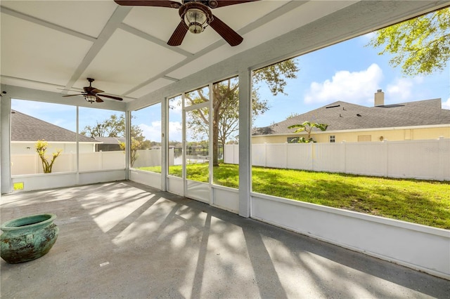 unfurnished sunroom featuring ceiling fan and plenty of natural light