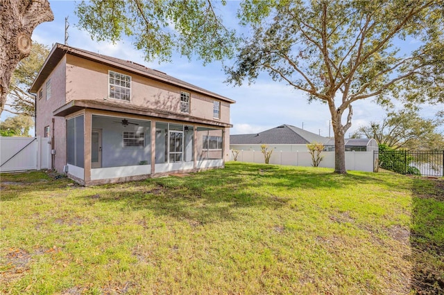 back of property with a lawn, a fenced backyard, a sunroom, and stucco siding