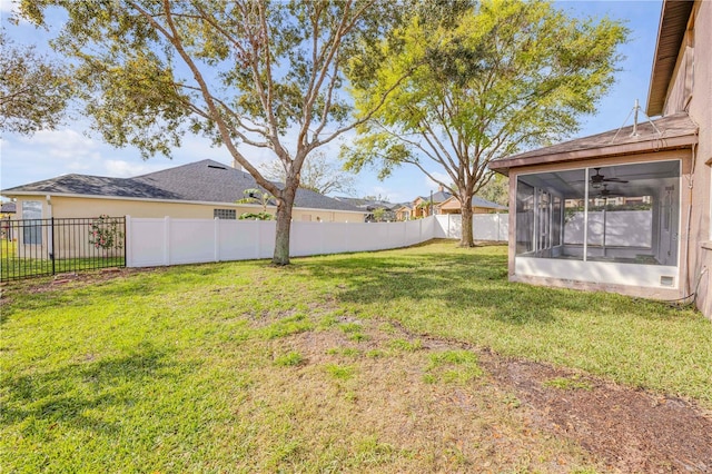 view of yard with a sunroom and a fenced backyard