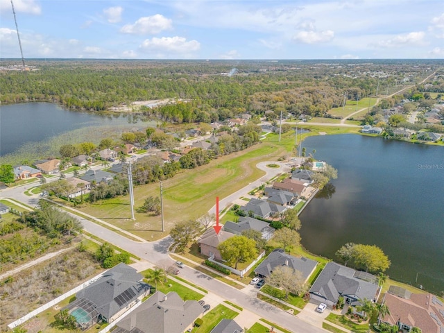 aerial view featuring a forest view, a water view, and a residential view