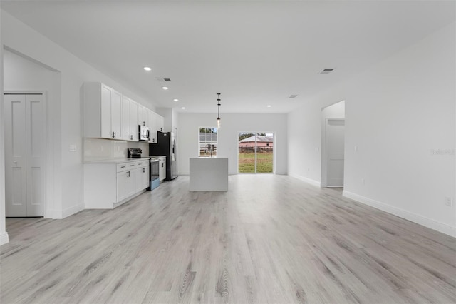 unfurnished living room with recessed lighting, visible vents, light wood-style flooring, and baseboards