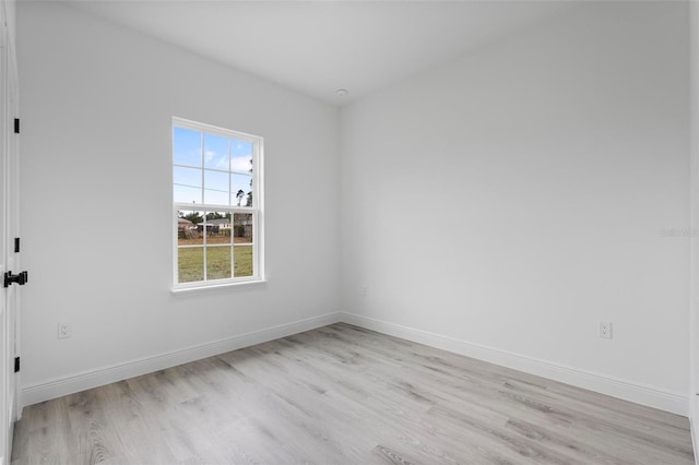 spare room with light wood-style flooring and baseboards