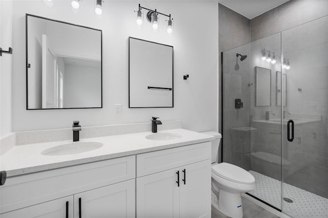 full bath featuring double vanity, a stall shower, and a sink