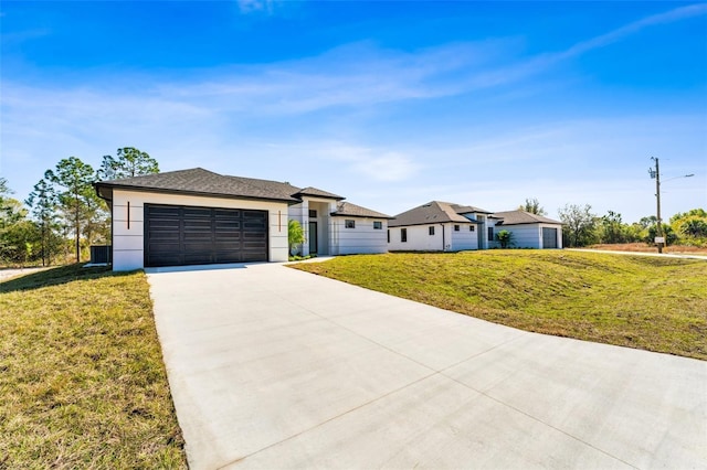 view of front of property with an attached garage, concrete driveway, and a front yard