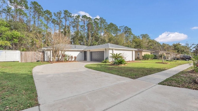 ranch-style home with a garage, driveway, a front lawn, and fence