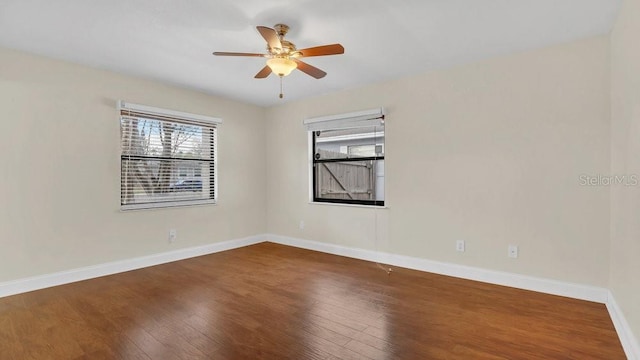 unfurnished room featuring ceiling fan, hardwood / wood-style floors, and baseboards