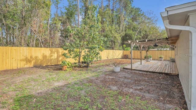 view of yard featuring a fenced backyard, a deck, and a pergola