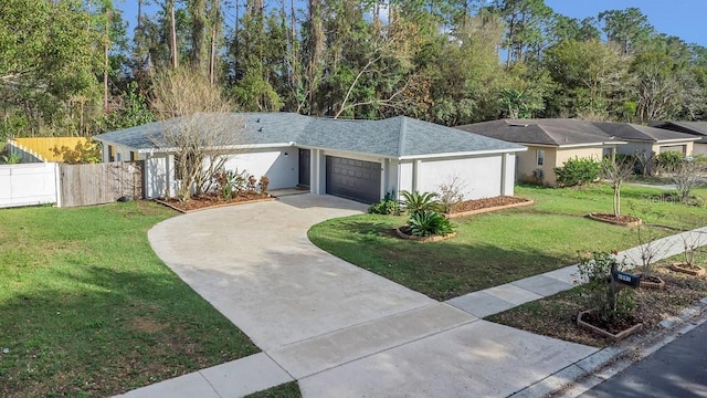 view of front of property featuring driveway, an attached garage, fence, a front lawn, and stucco siding