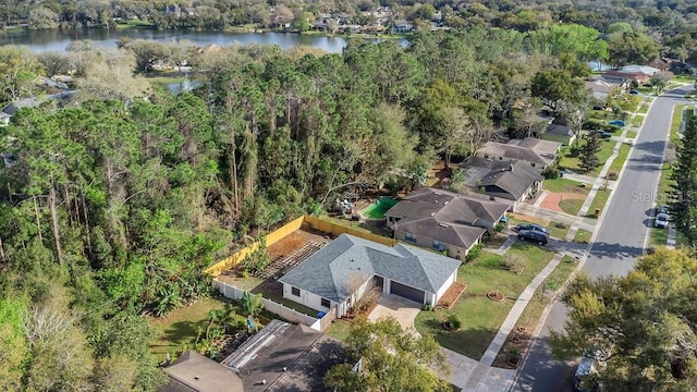 bird's eye view with a water view and a view of trees