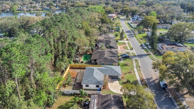 drone / aerial view with a water view and a residential view