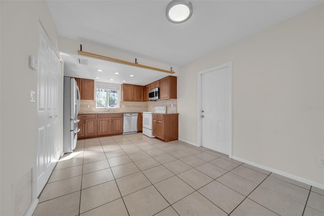 kitchen featuring stainless steel appliances, light countertops, visible vents, and decorative backsplash