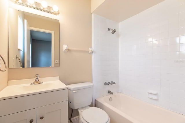 bathroom with bathing tub / shower combination, toilet, and vanity