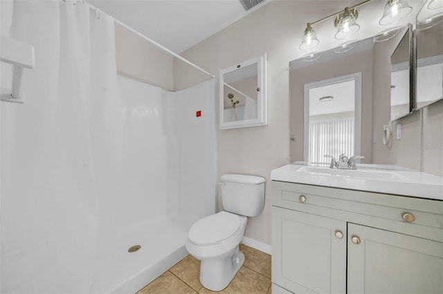 bathroom featuring curtained shower, toilet, vanity, baseboards, and tile patterned floors