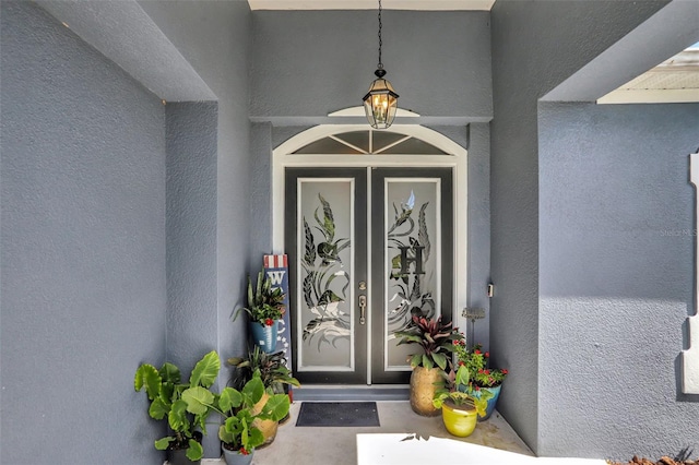 entrance to property with stucco siding