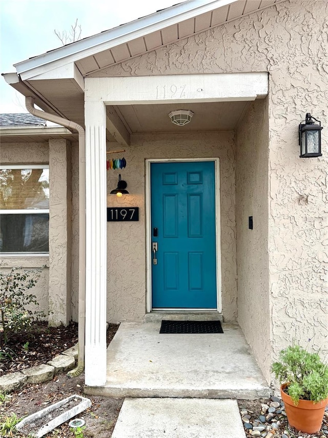 doorway to property with stucco siding