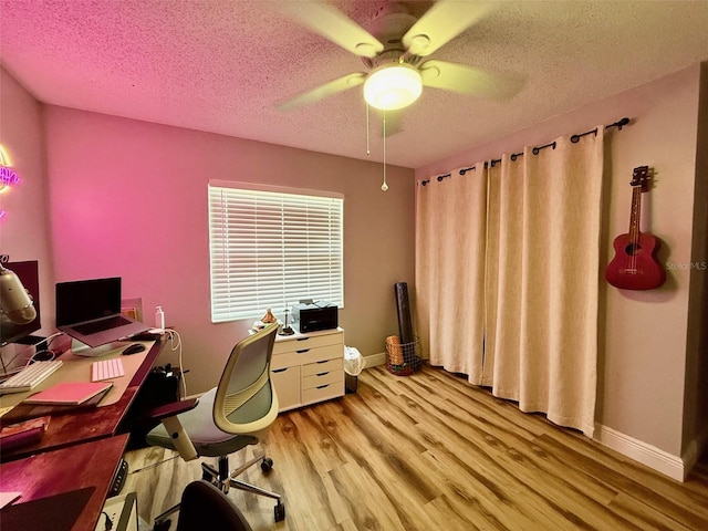 office with ceiling fan, a textured ceiling, light wood-style flooring, and baseboards